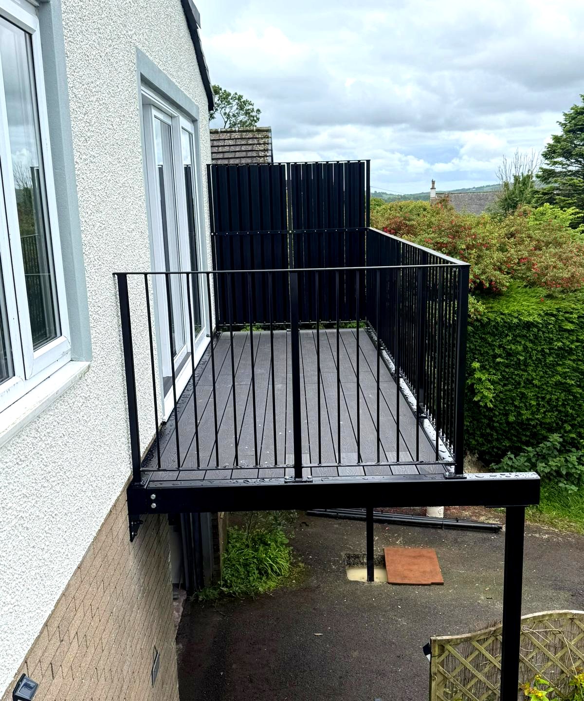 Black metal balustrade on a walk-out balcony with composite decking, Crummock