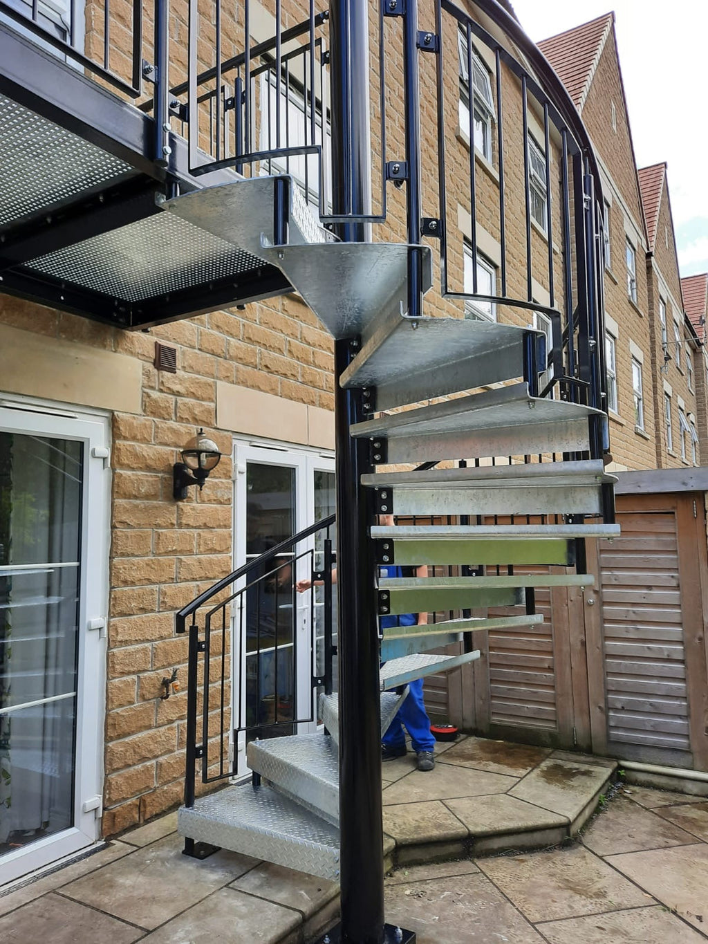 External steel spiral staircase beside patio doors