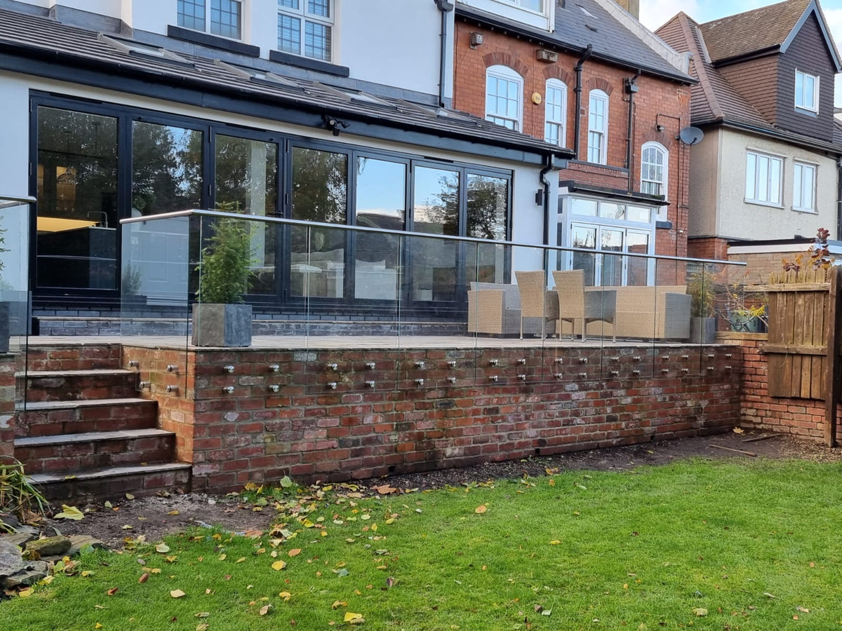 Long run of side fixed frameless glass balustrade on brickwork, Chesterfield