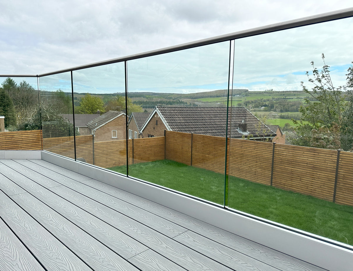 System 4 frameless glass balustrade in a base channel along a composite decked terrace