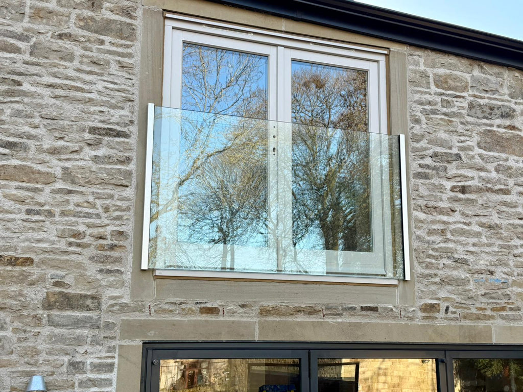 Frameless glass Juliet balcony with the glass in side channels and no handrail