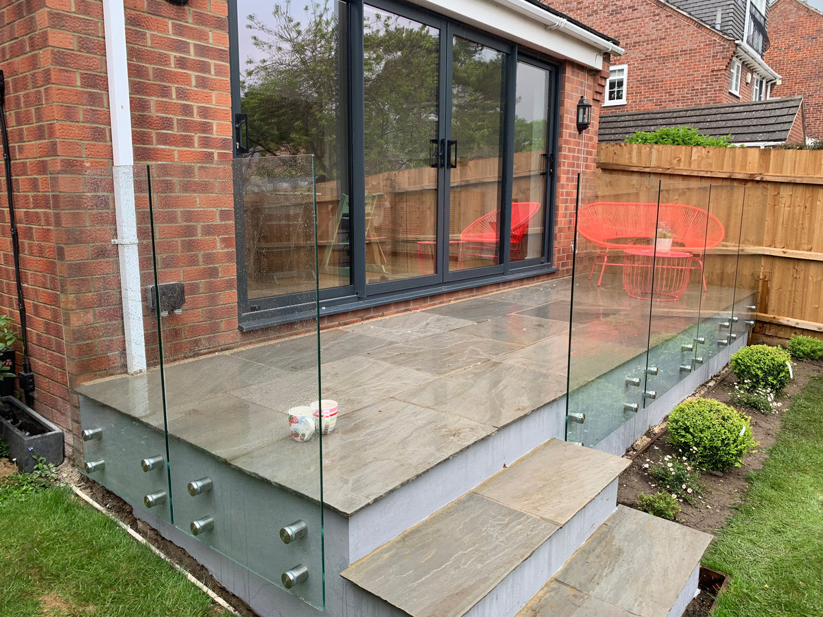 Frameless glass fencing around a patio seating area