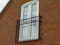 Galvanised steel Juliet balcony with square posts topped with spheres