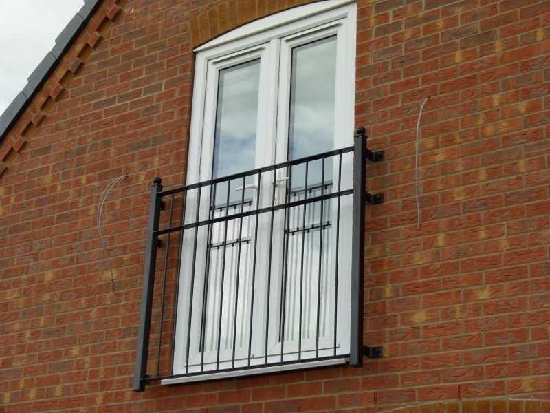 Galvanised steel Juliet balcony with square posts topped with spheres