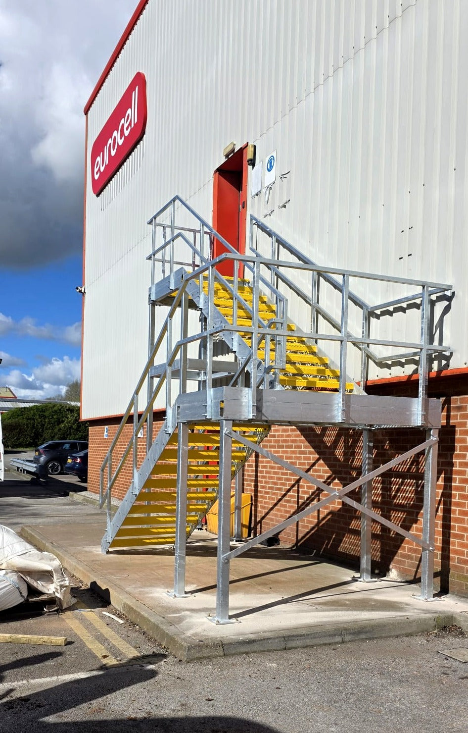 Front view of a galvanised fire escape staircase serving a first floor door