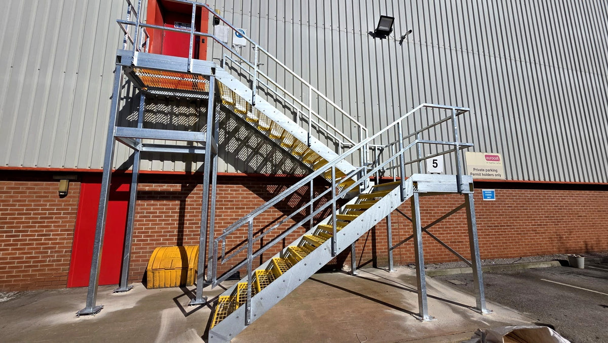 Galvanised steel fire escape staircase with half landings on a commercial unit, Eurocell