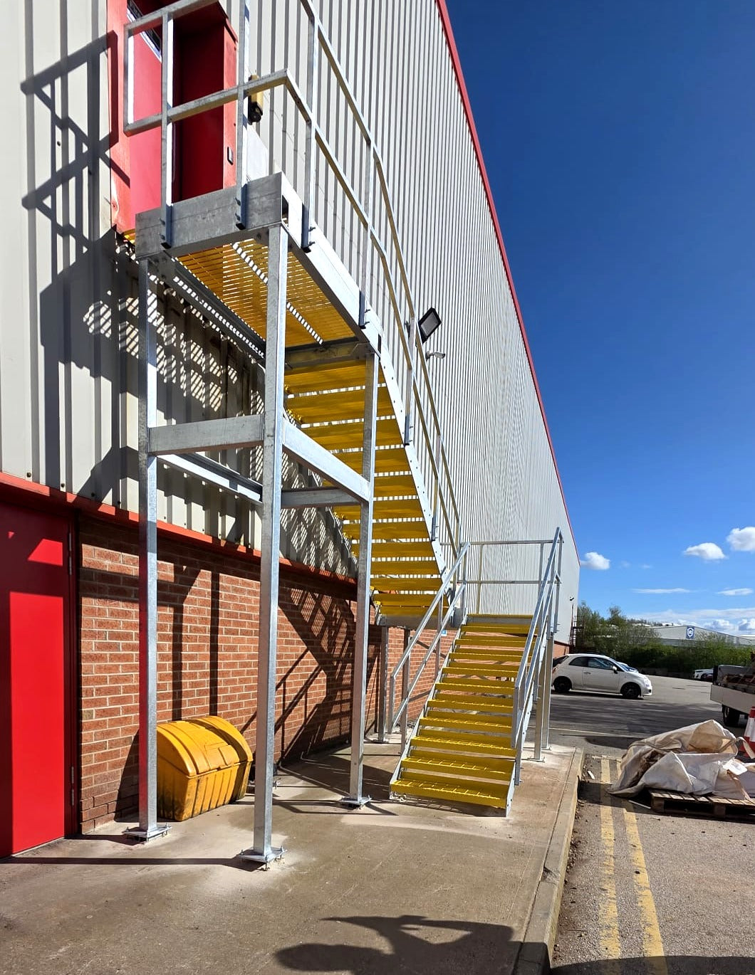 Side view of a galvanised steel fire escape staircase on a commercial building