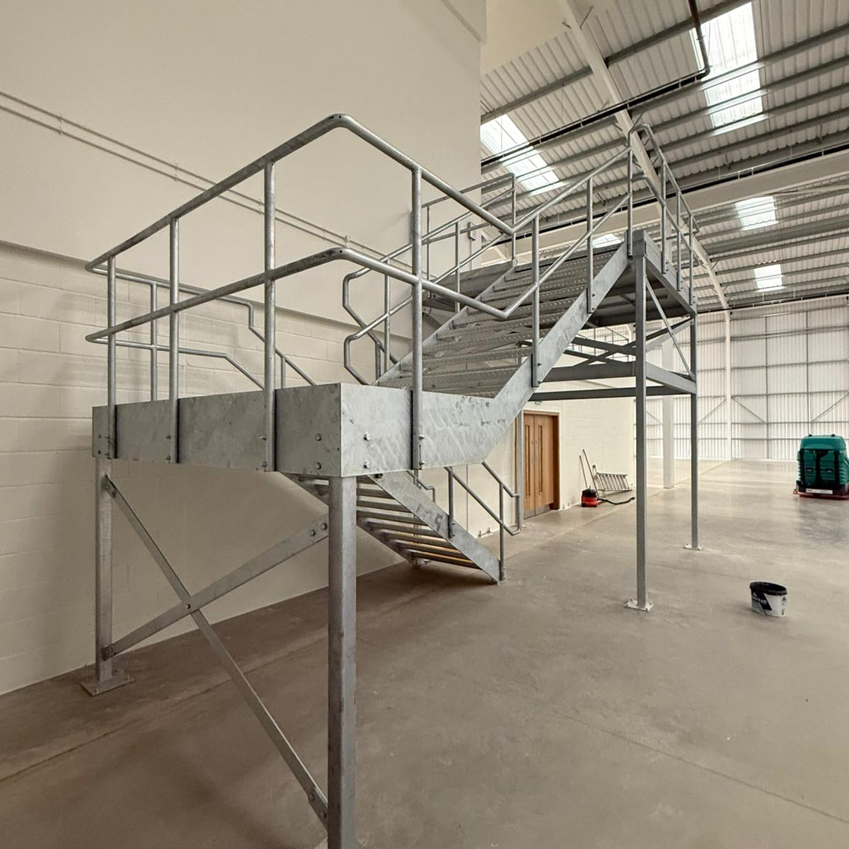 Galvanised steel fire escape staircase being installed