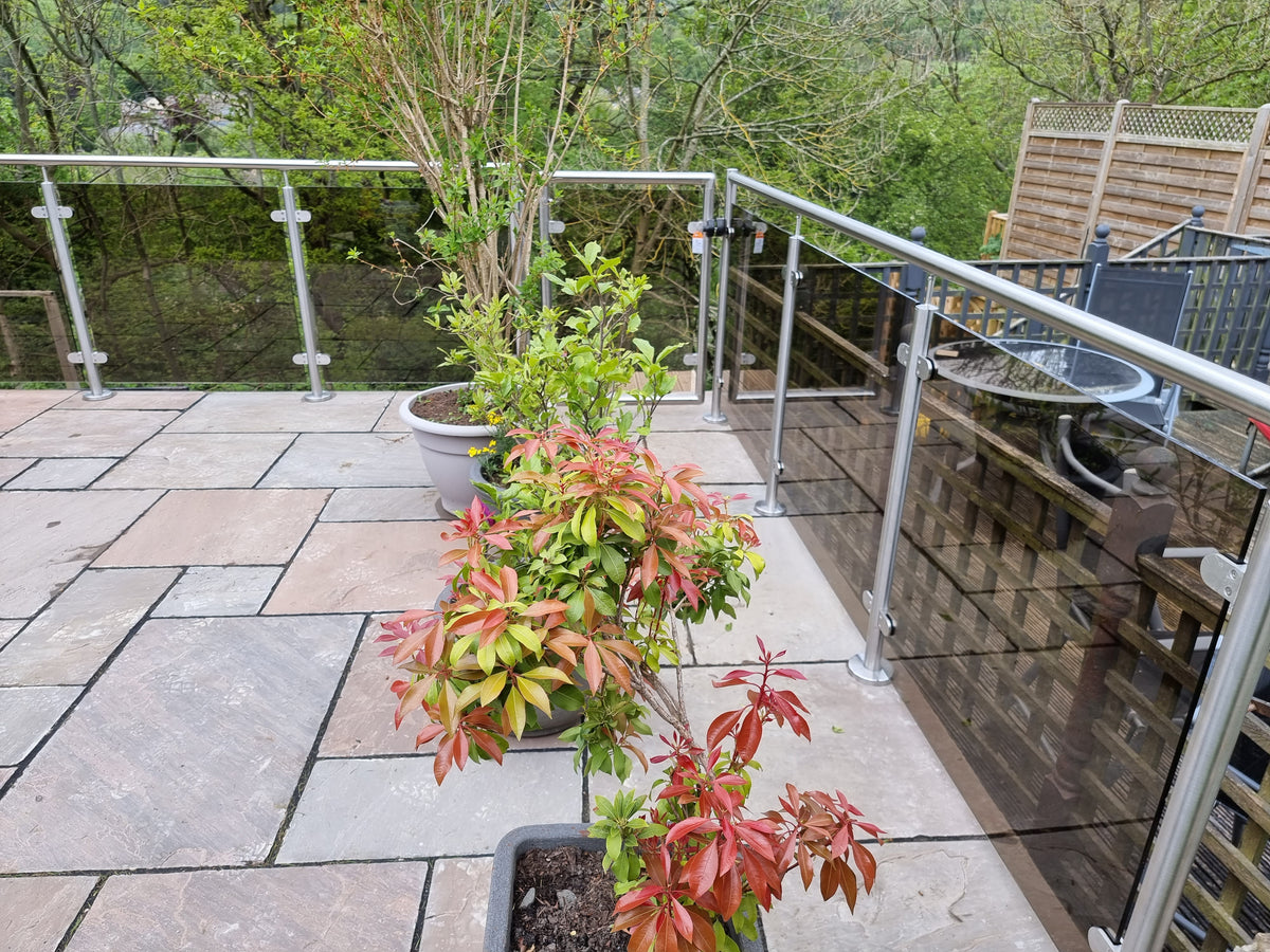 Balcony balustrade infilled with grey tinted toughened glass