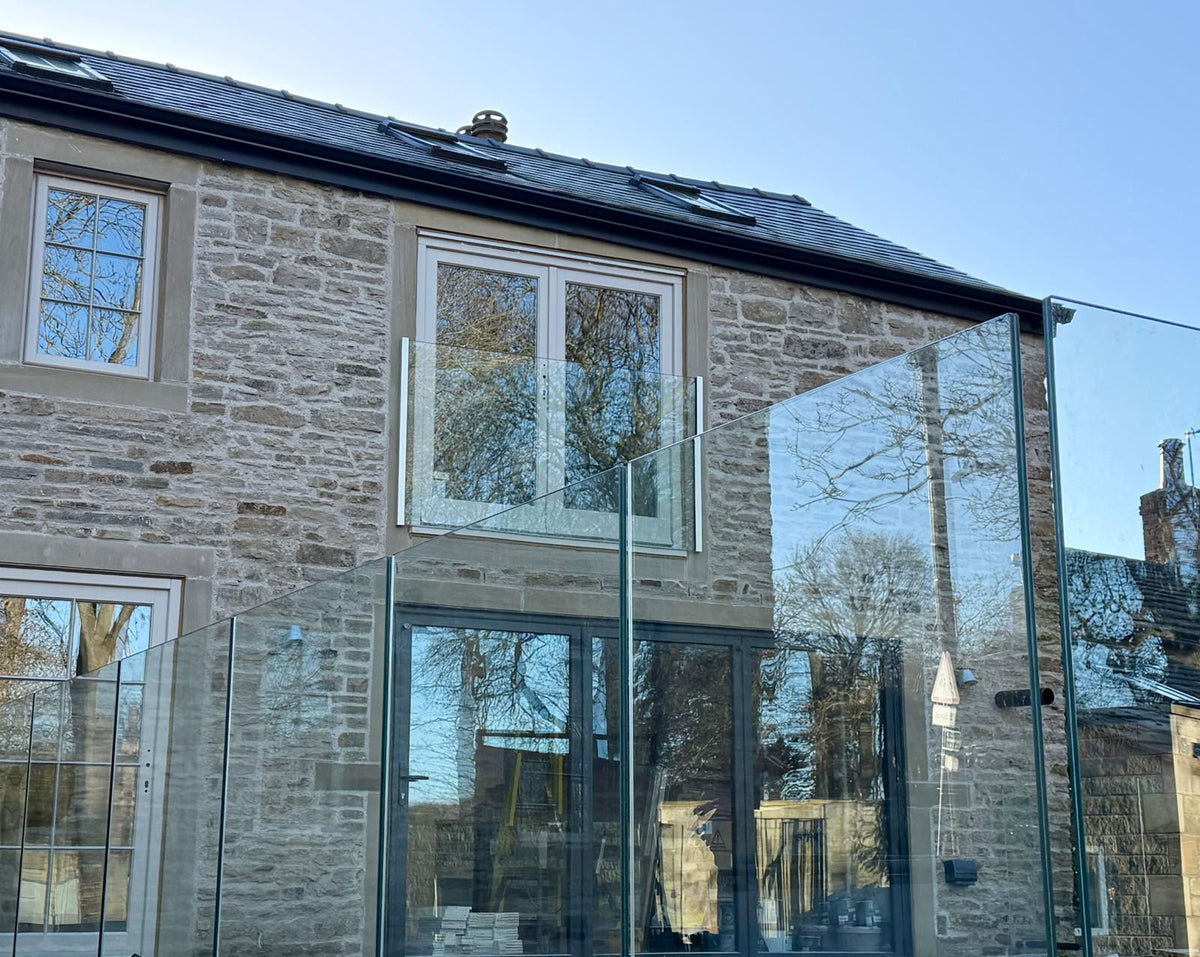 Frameless glass Juliet balcony installed, glass held in side channels