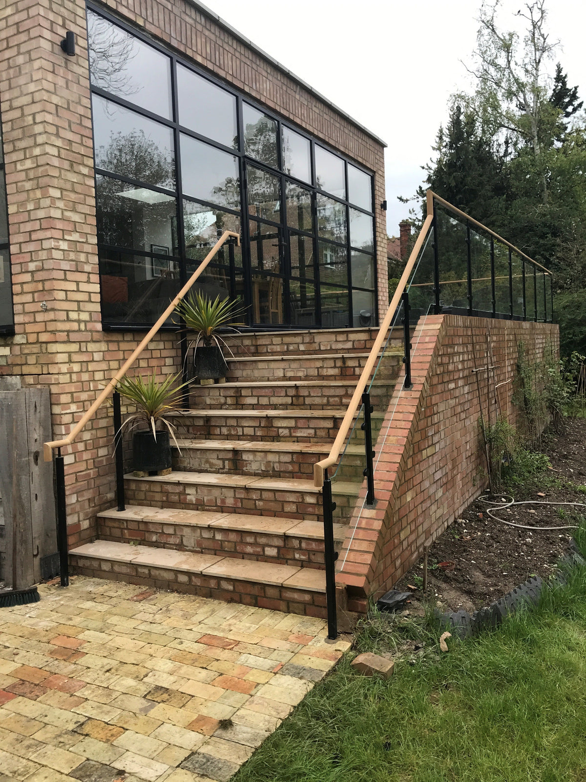 Powder coated glass balustrade with a timber handrail, Cambridge
