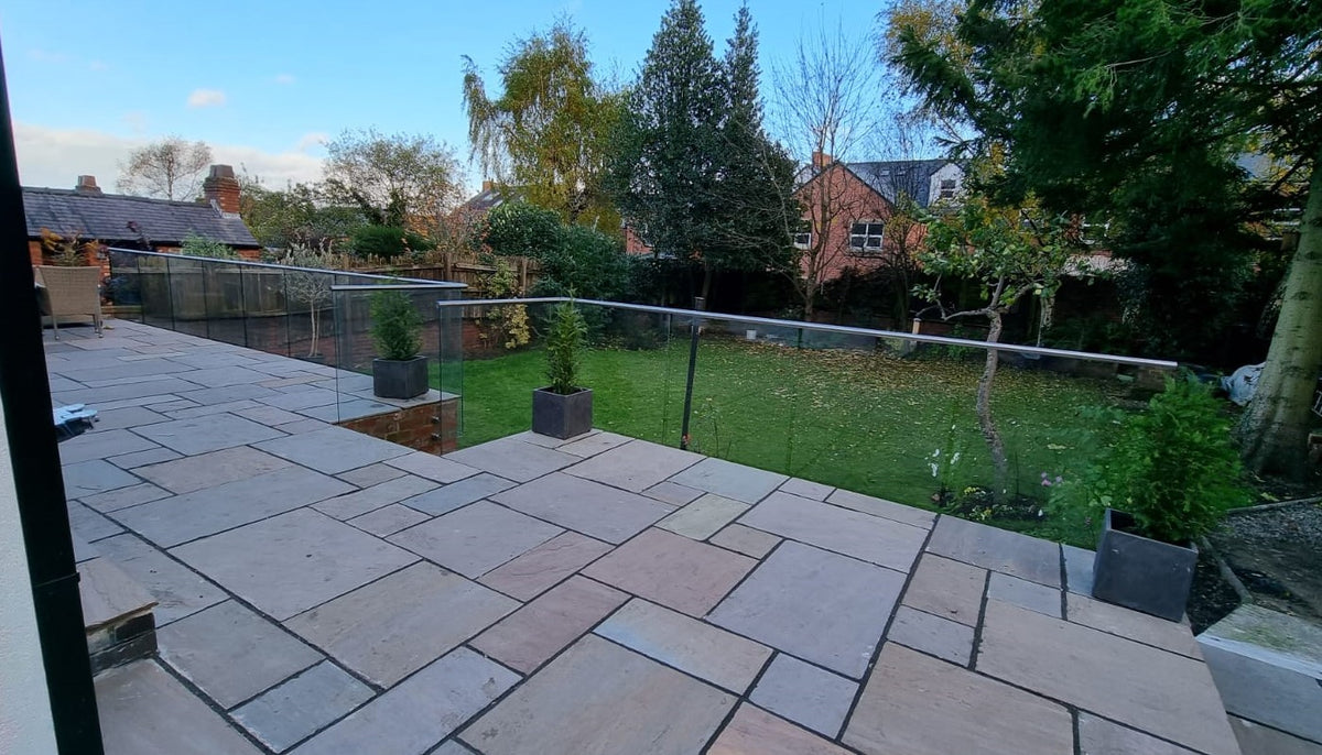 Frameless glass fence bolted to paving, no posts or channel