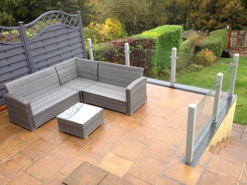 Laminated glass panels forming a terrace fence held in stainless clamps