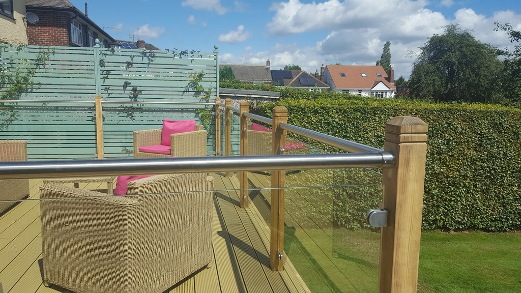 Toughened glass panels in a decking balustrade