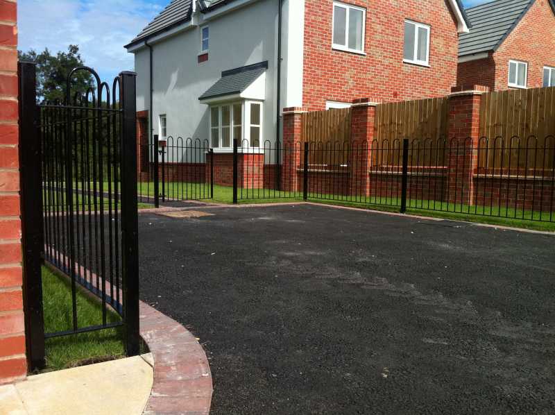 Hoop top railings to a boundary wall