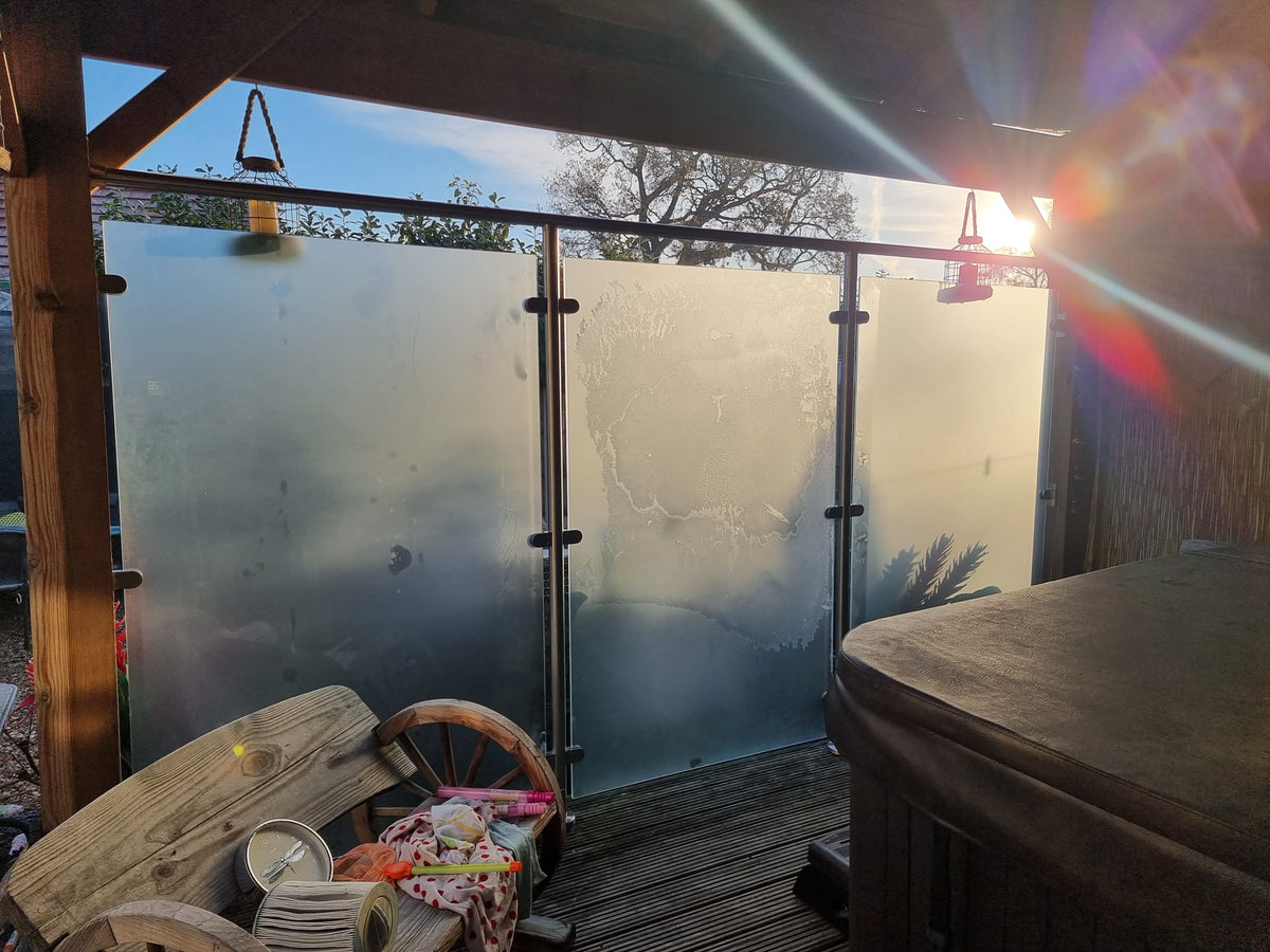 Frosted glass privacy screen beside a hot tub