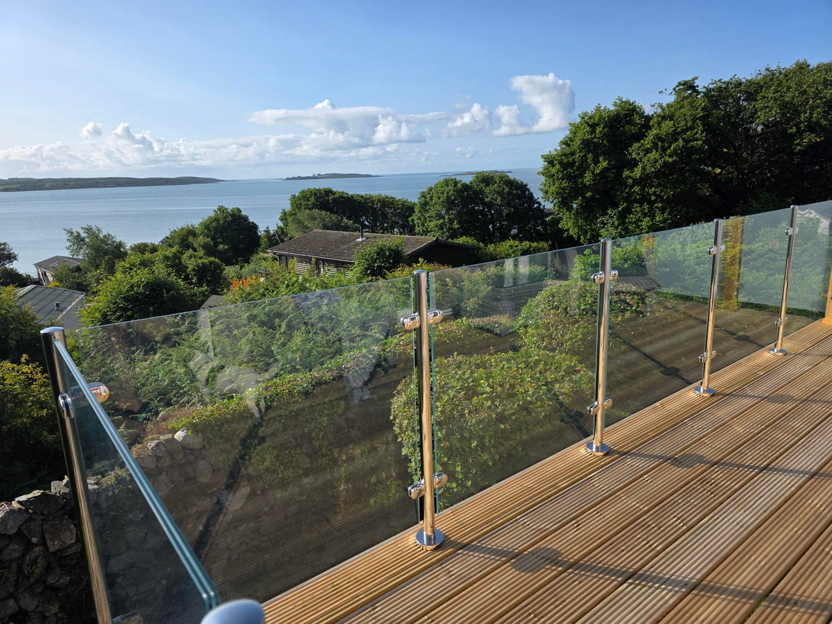 Run of 10.8mm laminated glass balustrade panels along a decked terrace overlooking the sea
