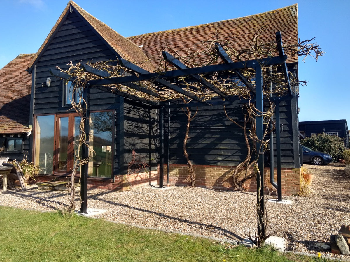 Bespoke galvanised steel garden pergola in a UK garden