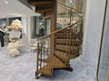 Gold powder coated internal steel spiral staircase in a showroom