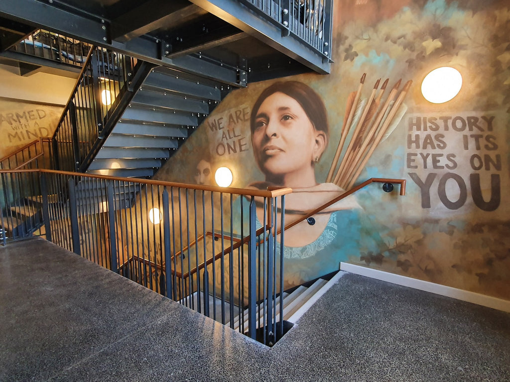 Open riser steel staircase and landing guarding with bar infill balustrade and timber handrail
