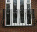 Ornate galvanised steel Juliet balcony with Spanish bow bars, rings and collars