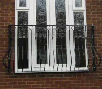 Ornate galvanised steel Juliet balcony with Spanish bow bars, rings and collars