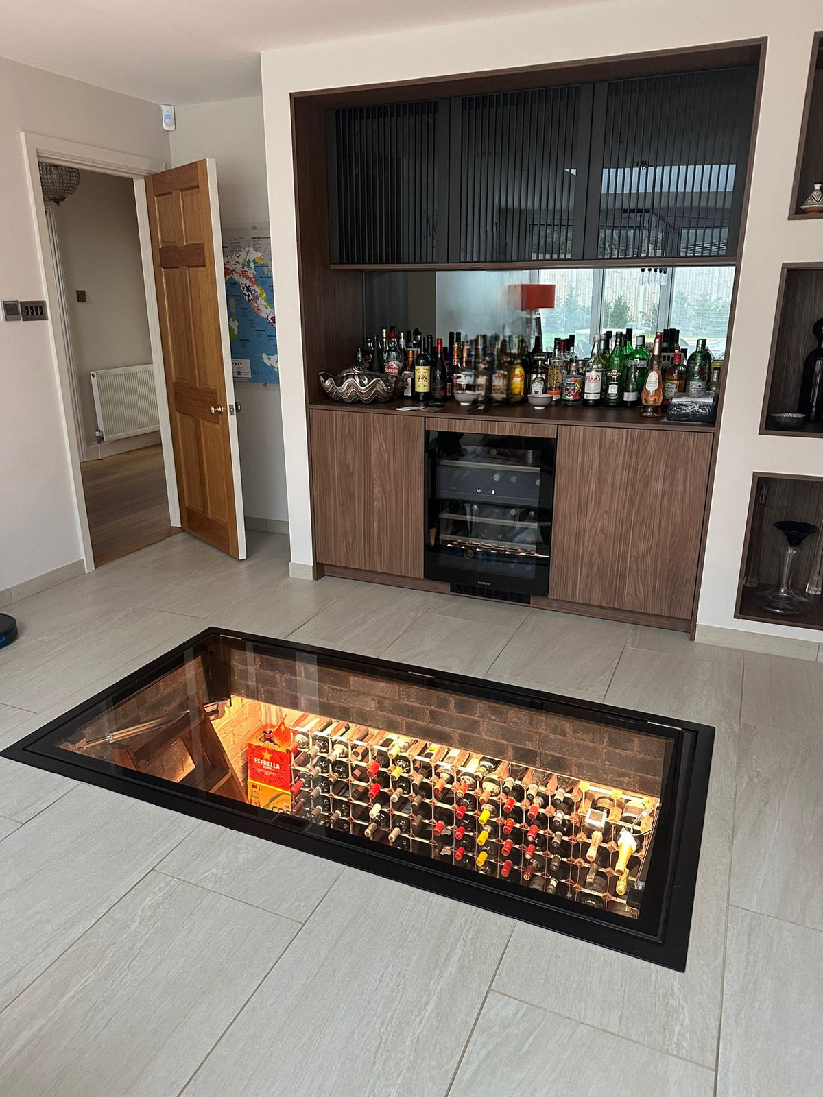 Electric motorised glass floor wine cellar door