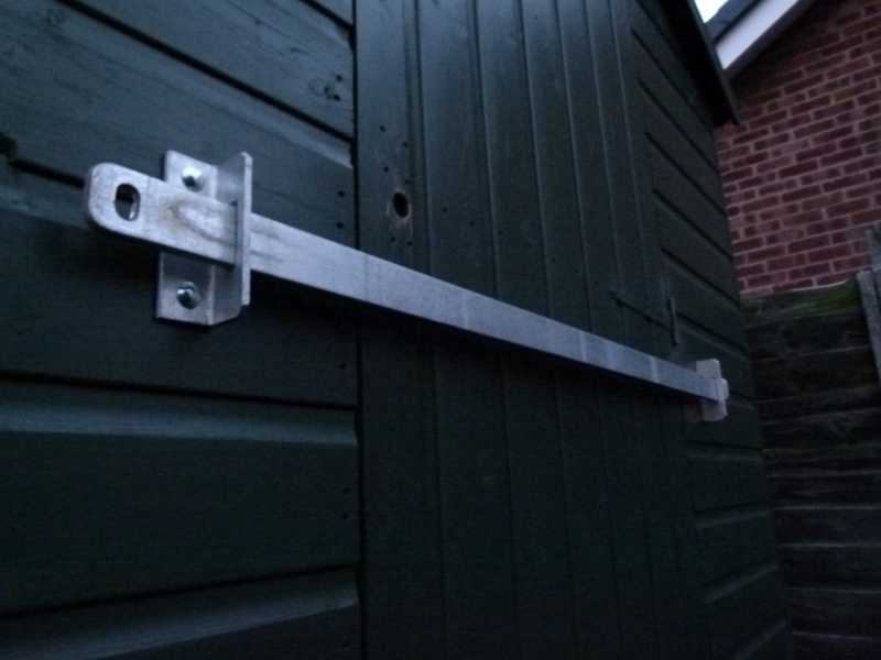 Shed security bar in place across a door opening