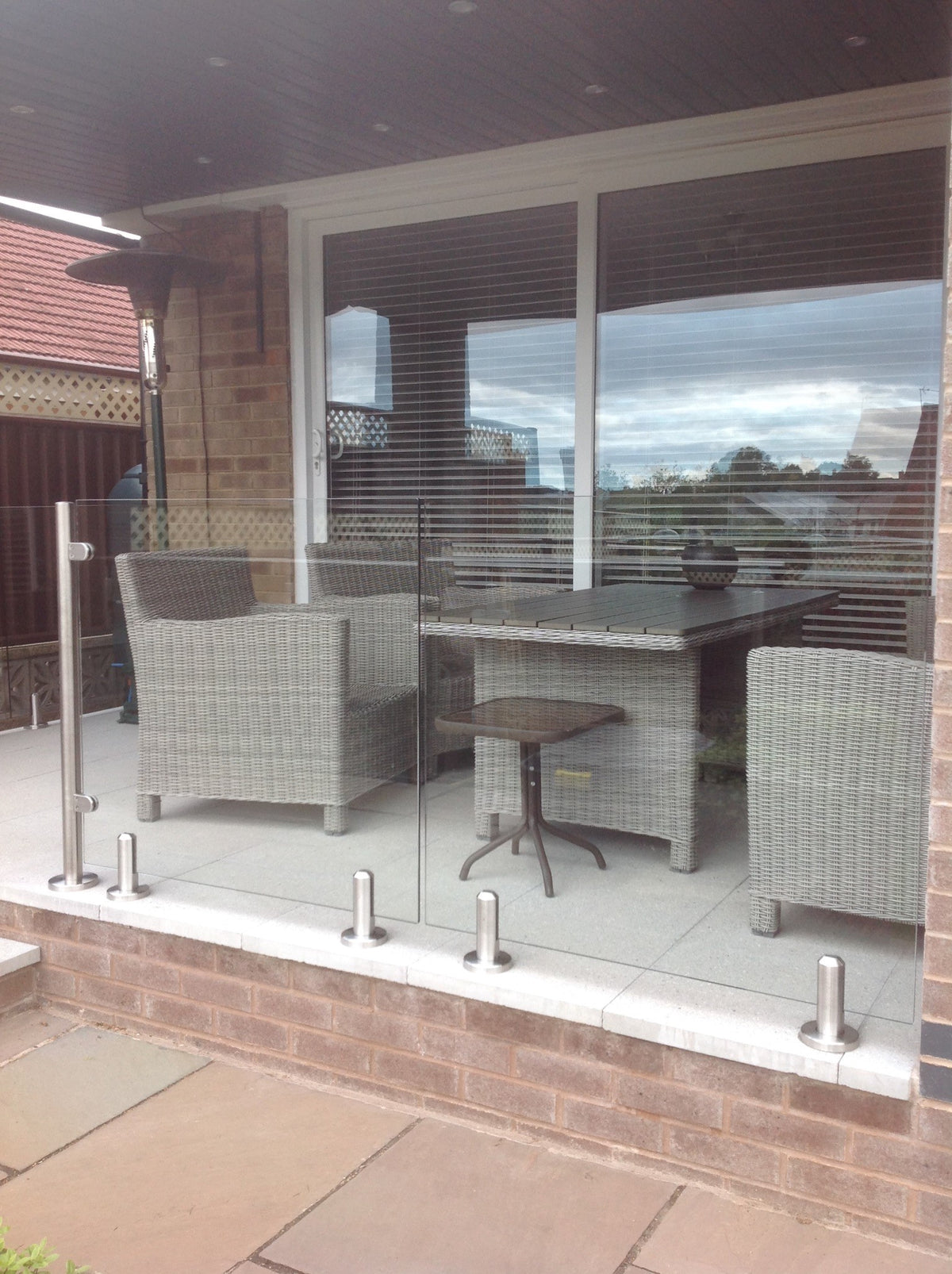 Spigot mounted glass balustrade around a patio