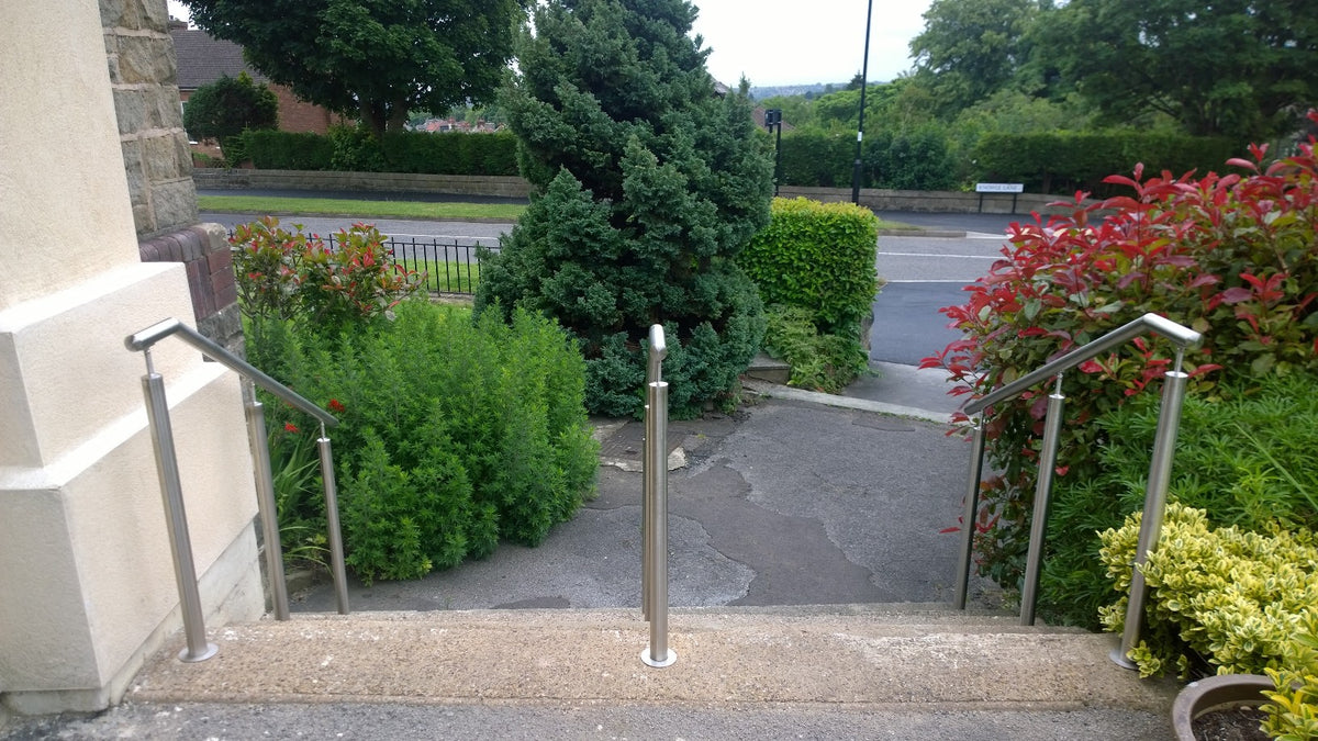 Stainless steel handrail on posts following a flight of steps
