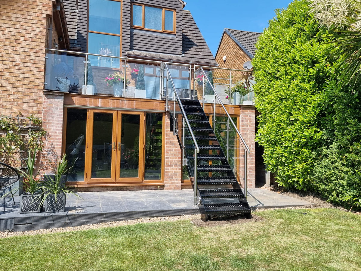 Powder coated steel garden staircase with glass balustrade and matching gate