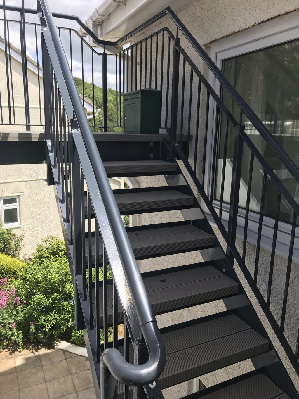 Anthracite powder coated steel staircase with metal railings and composite decking treads