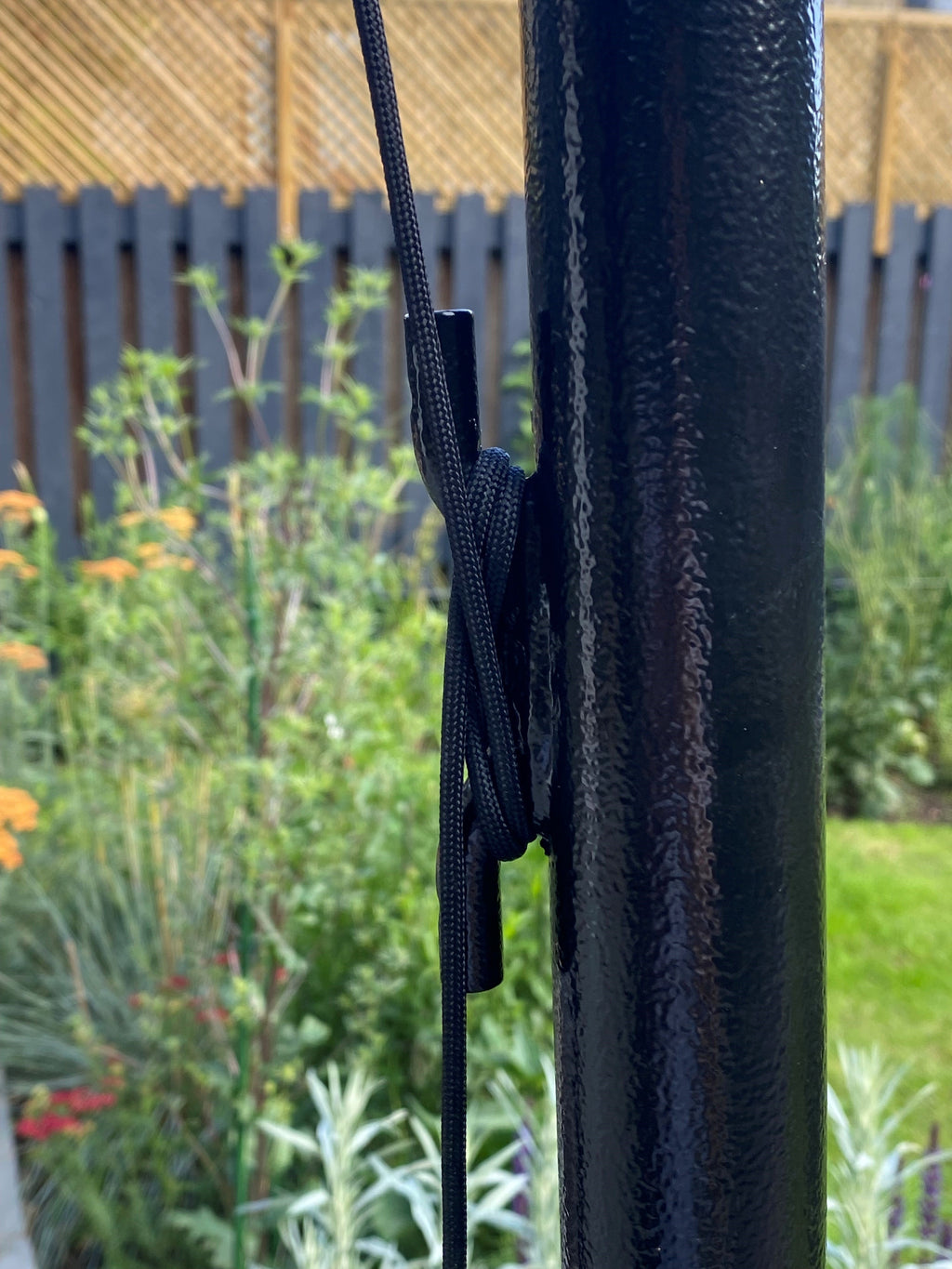 Tie-off cleat fitted to a shade sail post for letting the sail off