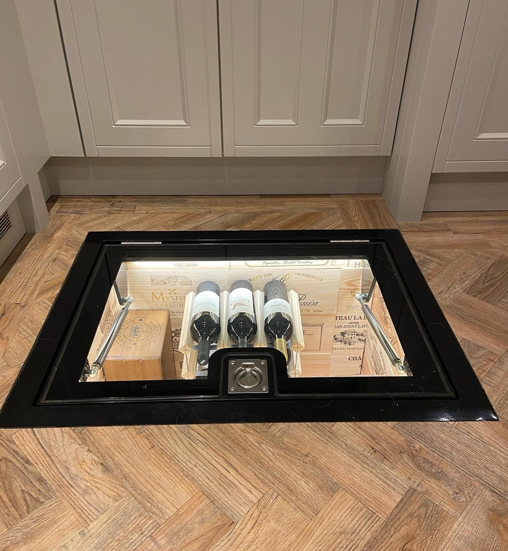 Glass cellar door in a kitchen floor above an underground wine store