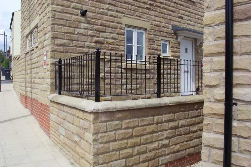 Made to measure steel wall top railings between brick piers