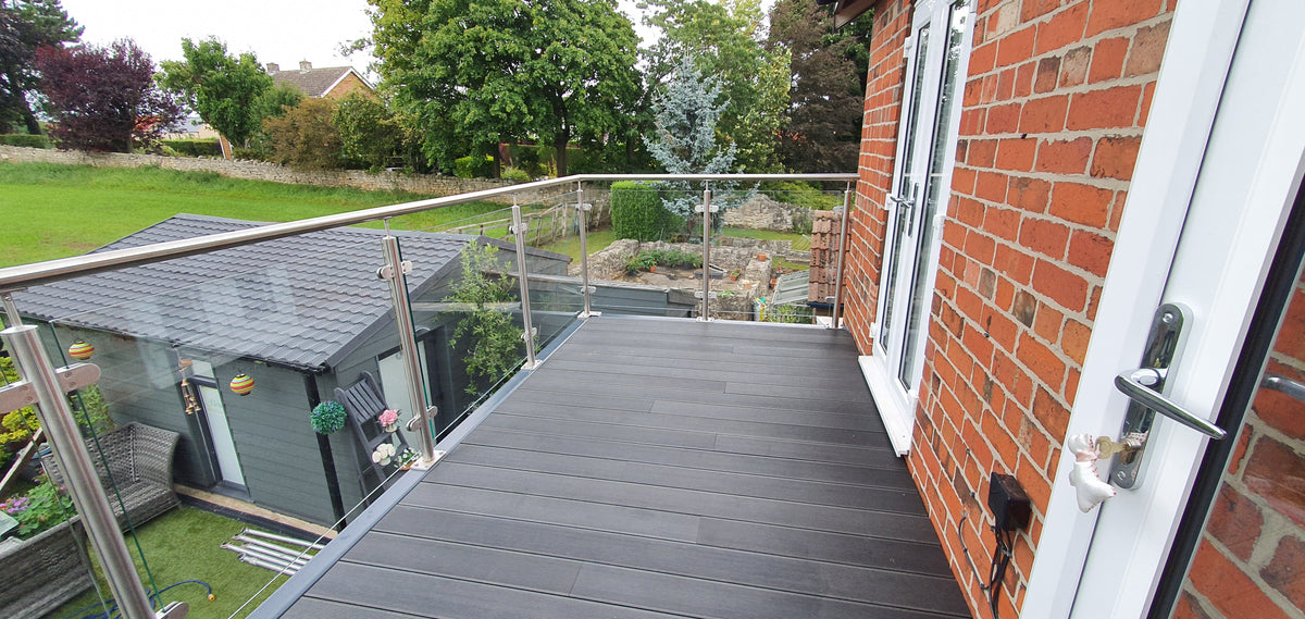 Walk-out balcony with framed glass balustrade above a doorway