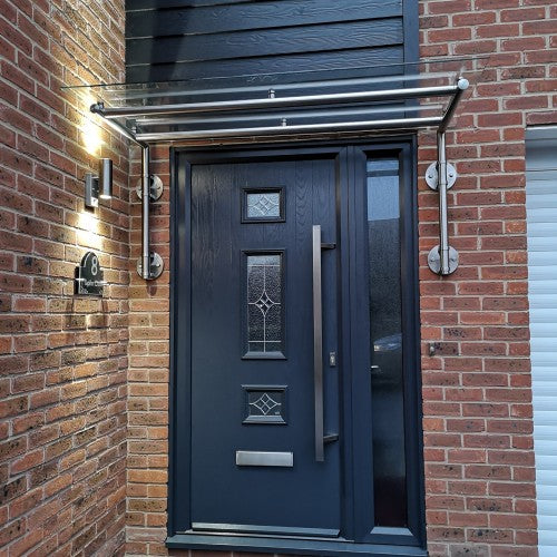 Wide span glass door canopy over a double door entrance