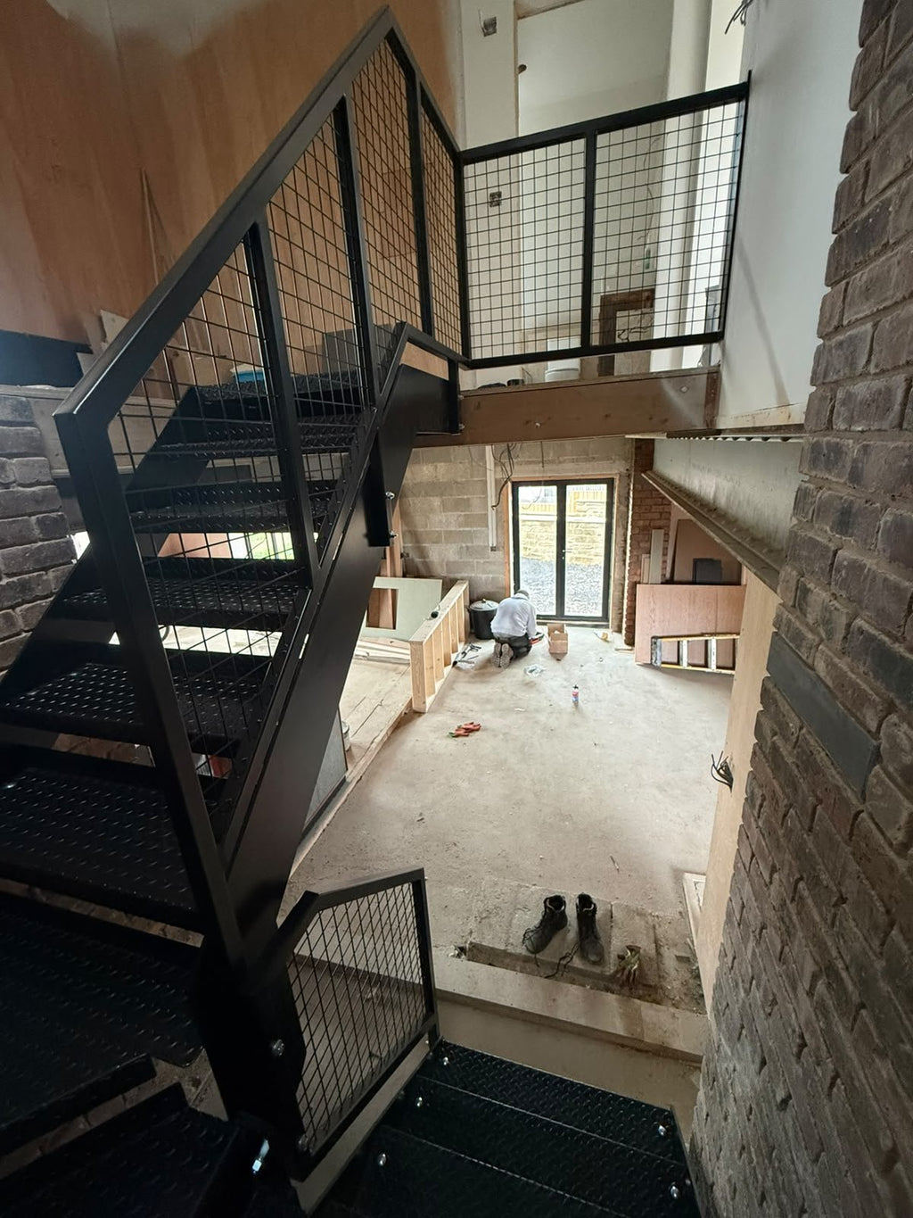Two inch welded wire mesh infill in 40 x 40mm box section balustrade frames to a steel staircase landing
