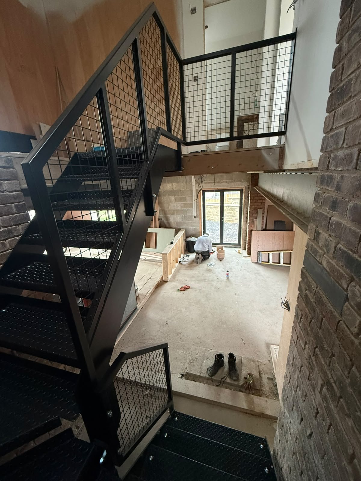 Two inch welded wire mesh infill in 40 x 40mm box section balustrade frames to a steel staircase landing
