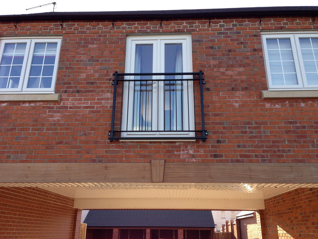 York Juliet balcony with flat bar frame and vertical infill bars on a new build home