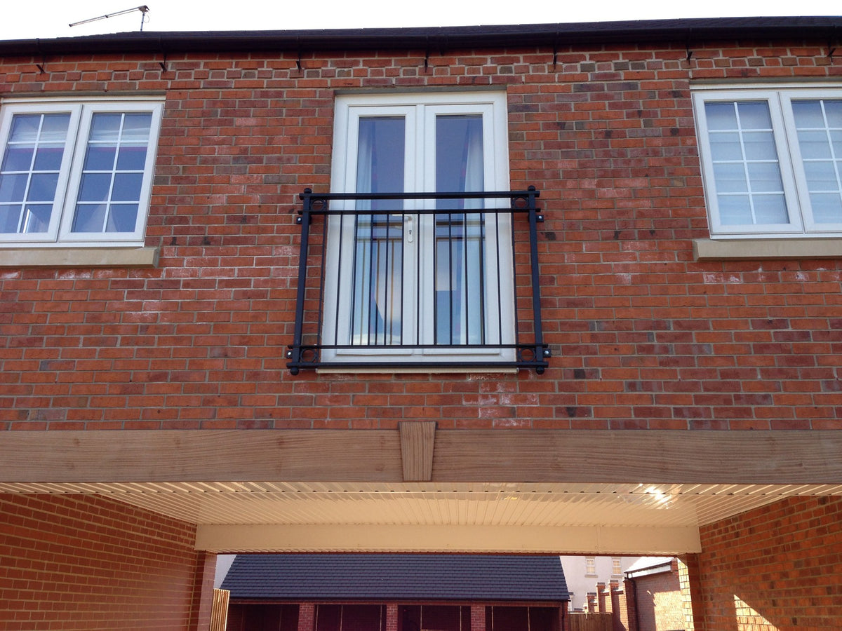 York Juliet balcony with flat bar frame and vertical infill bars on a new build home